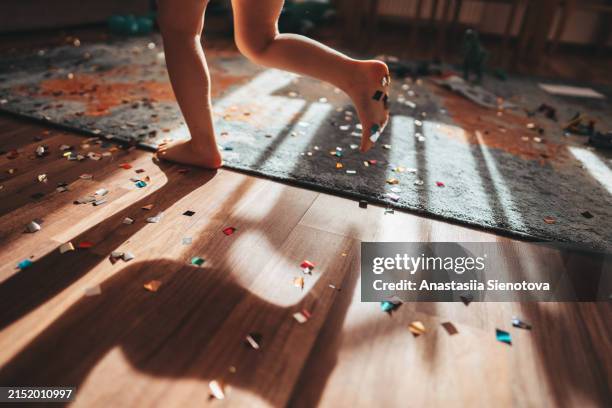 children's feet running across the floor with confetti - messy kids playroom stock pictures, royalty-free photos & images
