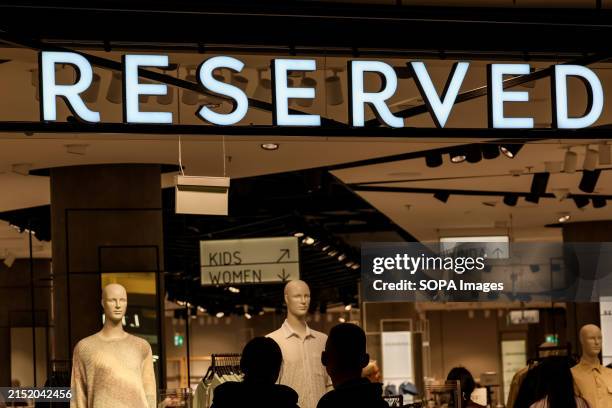 The Reserved logo is seen at the entrance of its shop in a high street in Warsaw.