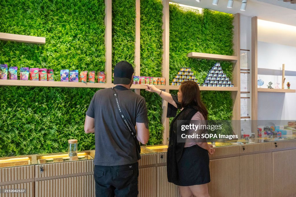 A seller is seen advising a customer about cannabis gummies...