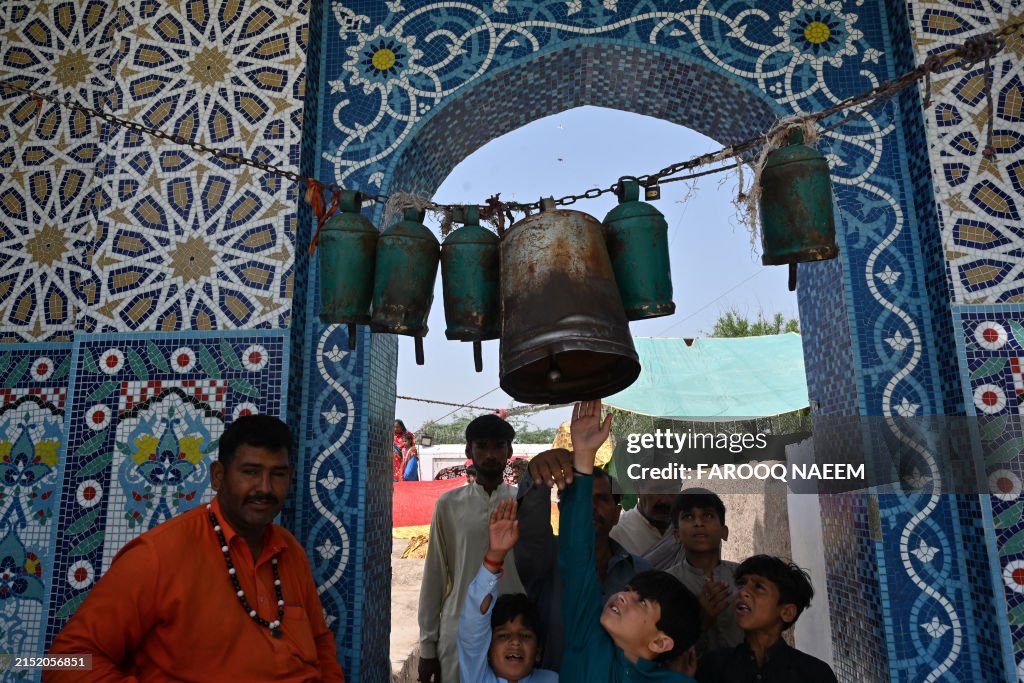 Pakistan Rufi Visitors rings the bell in a Sufi Shrine during annual Shah Jewana ...