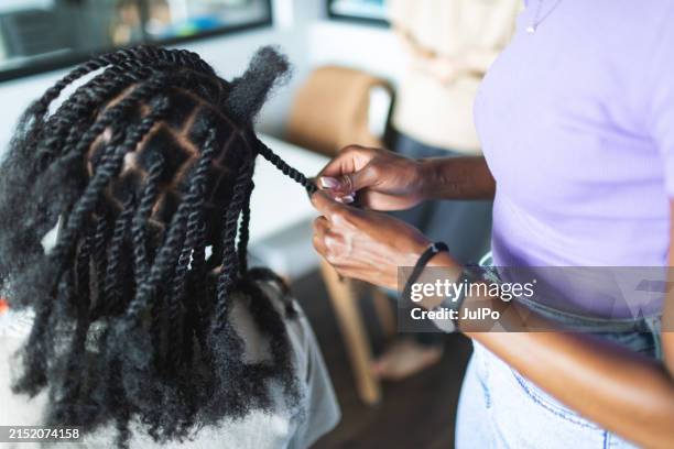 men's beauty - making braids - black woman hair stylist stock pictures, royalty-free photos & images