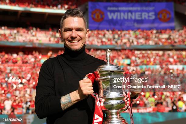 Manchester United Head Coach / Manager Marc Skinner poses with the trophy at the end of the Adobe Women's FA Cup Final match between Manchester...