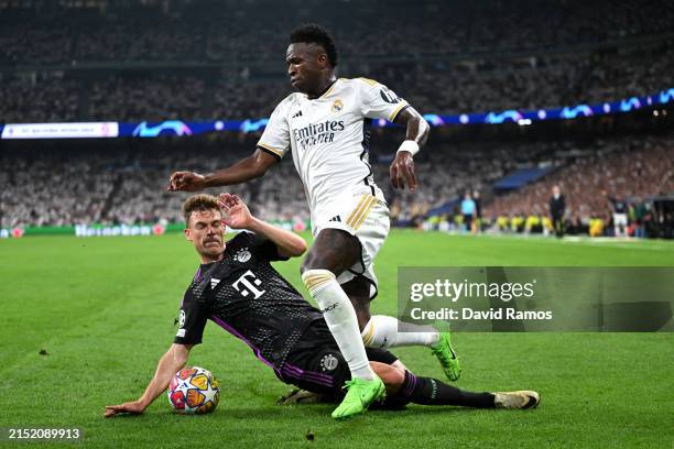 Joshua Kimmich of Bayern Munich battles for possession with Vinicius Junior of Real Madrid during the UEFA Champions League semi-final second leg...