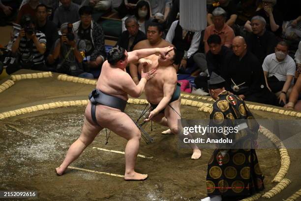 Sumotori wrestlers Sadanoumi and Kinboza of Makuuchi compete during the 7th fight of the first day of the Grand Sumo Tournament at Tokyo's Ryogoku...