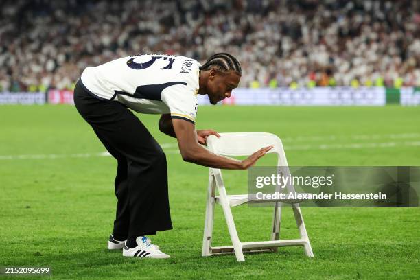 David Alaba of Real Madrid gestures after he is brought a chair by teammate Antonio Ruediger following the UEFA Champions League semi-final second...