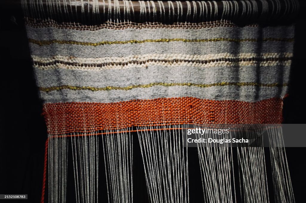 Fabric blanket being made from a historic loom