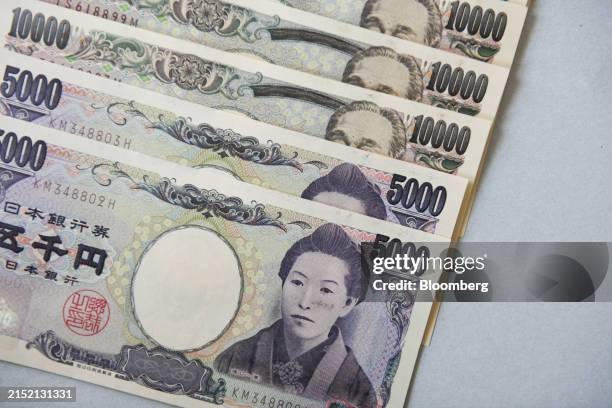 Japanese 10,000 yen and 5,000 yen banknotes arranged for a photograph in Tokyo, Japan, on Friday, May 10, 2024. The Bank of Japan offered to purchase...