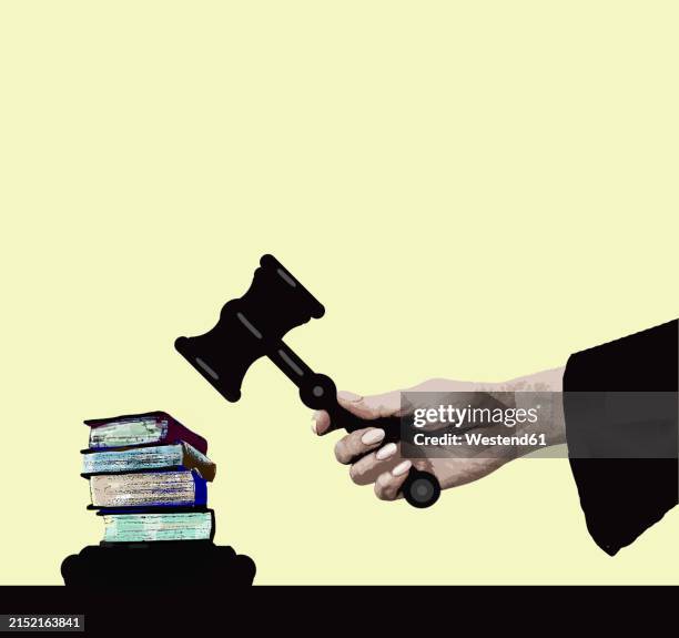 illustration of books under judge's gavel against yellow background - censorship stock illustrations