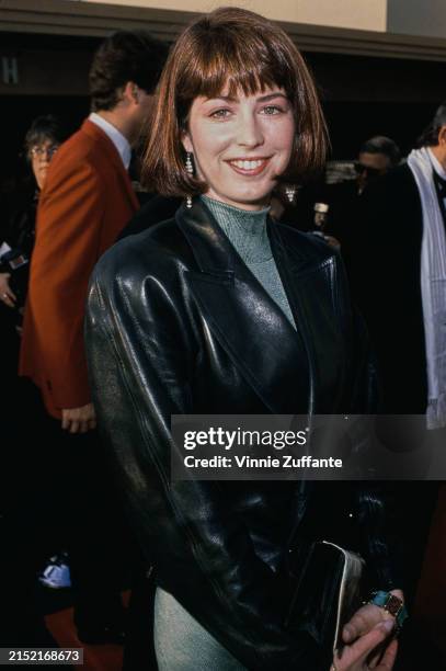 American actress Dana Delany, wearing a black leather jacket over a grey turtleneck dress, attends the 15th People's Choice Awards, at Walt Disney...