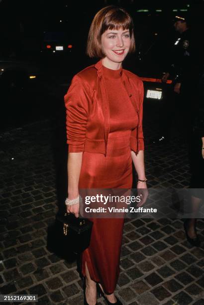 American actress Dana Delany, wearing a red dress with a matching cardigan, attends the 47th Golden Globe Awards, at the Beverly Hilton Hotel in...