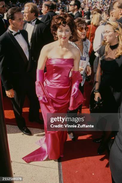 American actress Dana Delany, wearing a strapless pink evening gown with a pink evening wrap and pink evening gloves, attends the 44th Primetime Emmy...