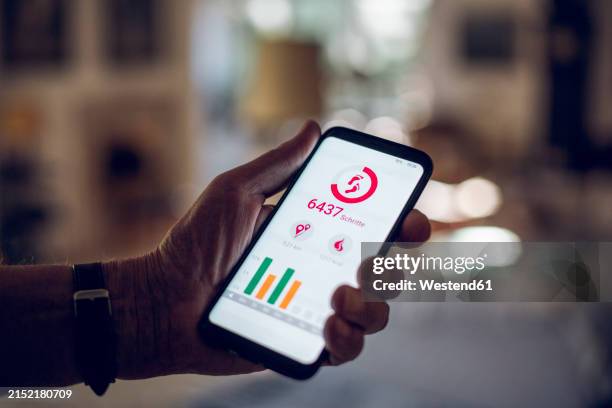 senior holding smartphone, using fitness app - appliqué stock pictures, royalty-free photos & images