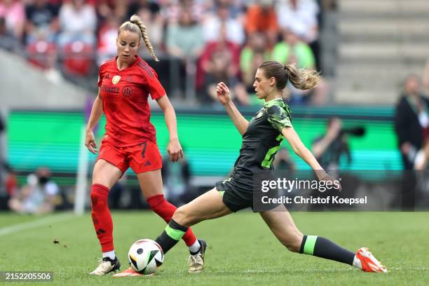 Giulia Gwinn of Bayern Munich is challenged by Jule Brand of VfL Wolfsburg during the Women's DFB Cup final match between FC Bayern München and VfL...