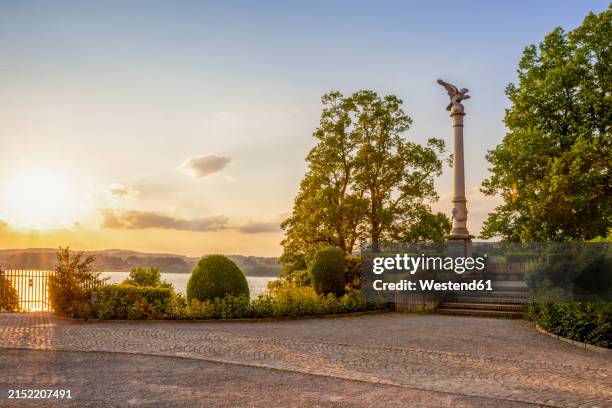 statue on column amidst trees in park at rapperswil, st gallen canton, switzerland - historic district stock pictures, royalty-free photos & images