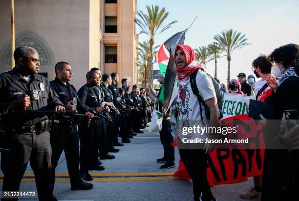 Los Angeles, CA Pro-Palestine supporters confront police and rally outside the Shrine Auditorium and Expo Hall during the Commencement Ceremony of...