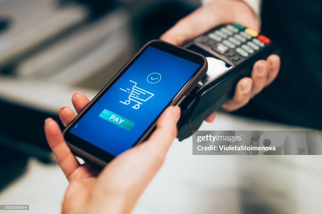 Customer paying bill using a mobile phone.
