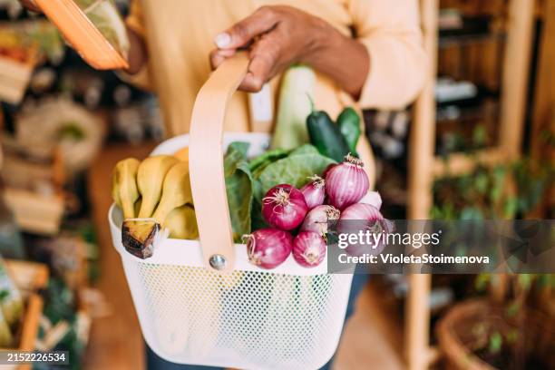 woman shopping at an organic market. - supermarket basket stock pictures, royalty-free photos & images