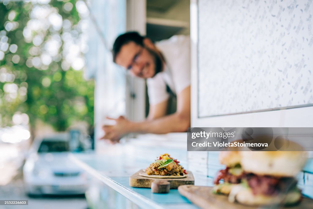 Happy young food truck owner.