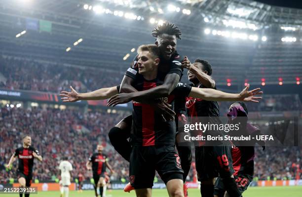 Josip Stanisic of Bayer Leverkusen celebrates with teammate Arthur after scoring his team's second goal during the UEFA Europa League 2023/24...