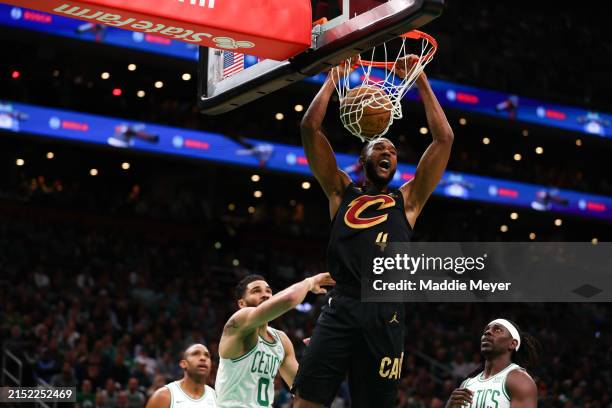Evan Mobley of the Cleveland Cavaliers dunks the ball past Jayson Tatum of the Boston Celtics during the first quarter in Game Two of the Eastern...
