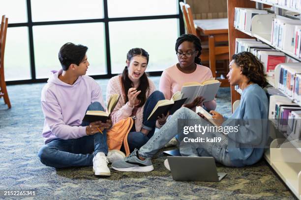 four high school students studying together in library - boy library stock pictures, royalty-free photos & images