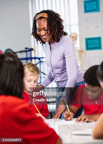 Middle school students in class doing writing assignment Middle school students in class doing writing assignment