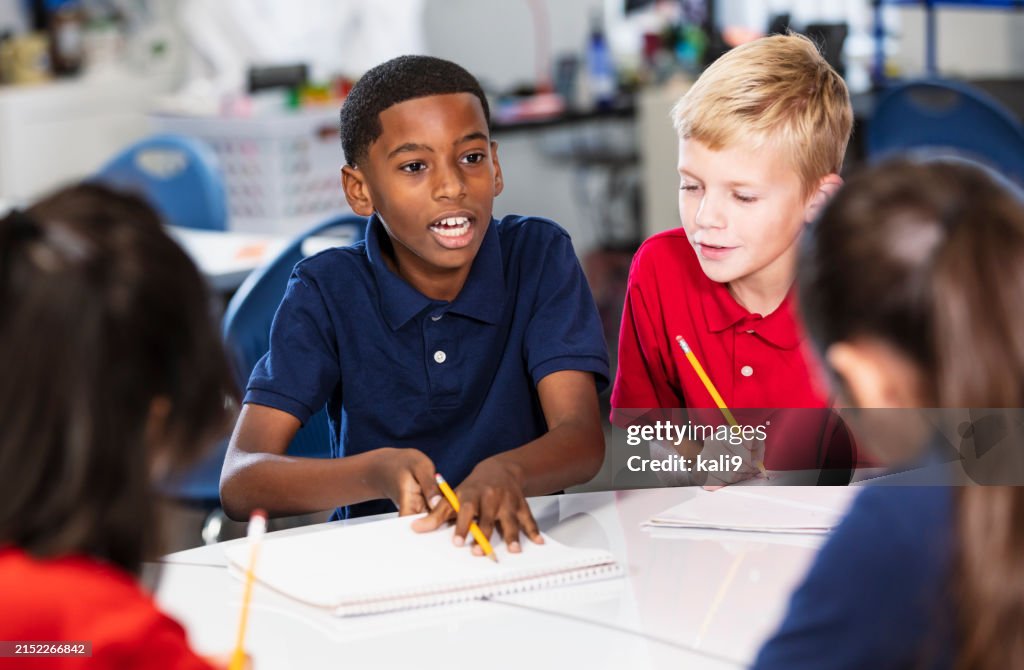 Middle school students in class doing writing assignment