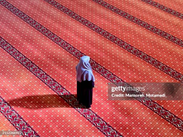 muslim woman praying in the mosque - saudi arabia woman stock pictures, royalty-free photos & images
