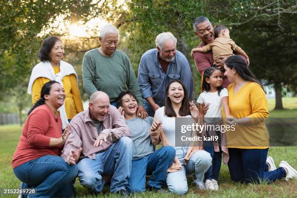 multiracial extended family taking group photo outdoors - uncle stock pictures, royalty-free photos & images