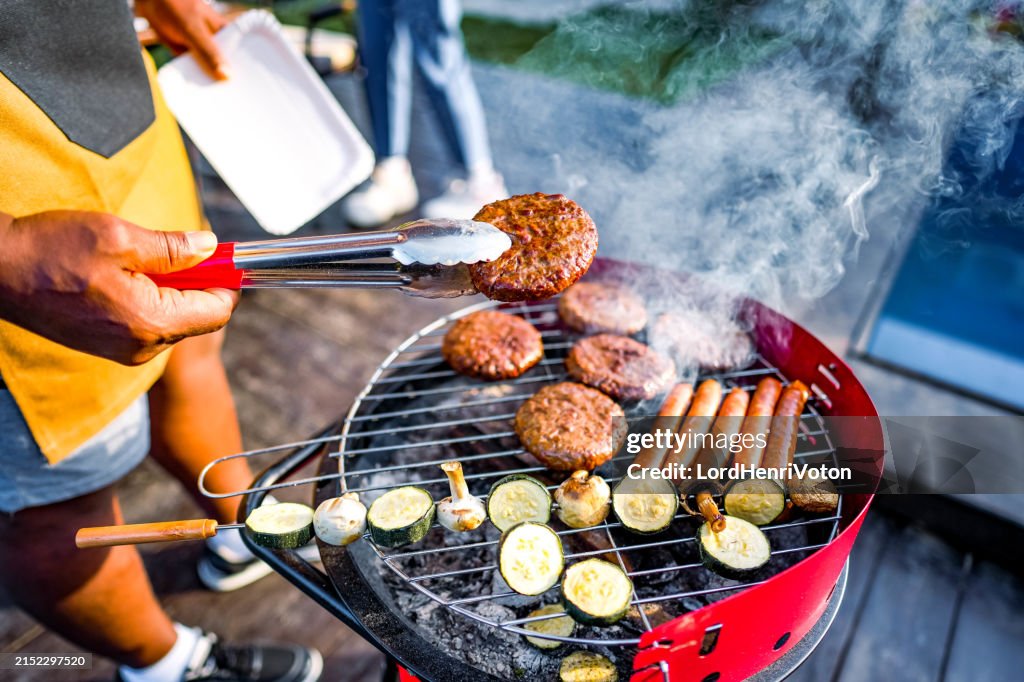 Man barbecuing meat in the garden