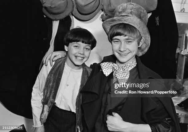English child actor Phil Collins posed on right in character as the Artful Dodger with fellow cast member Arthur Wild in a dressing room backstage...