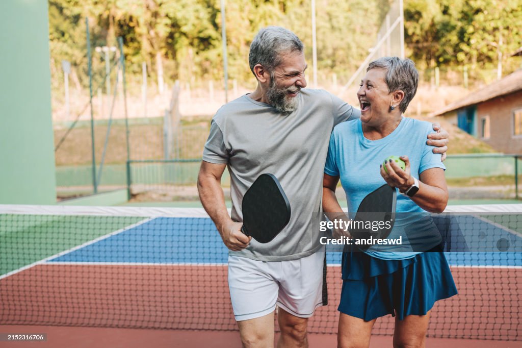 Senior couple playing pickleball