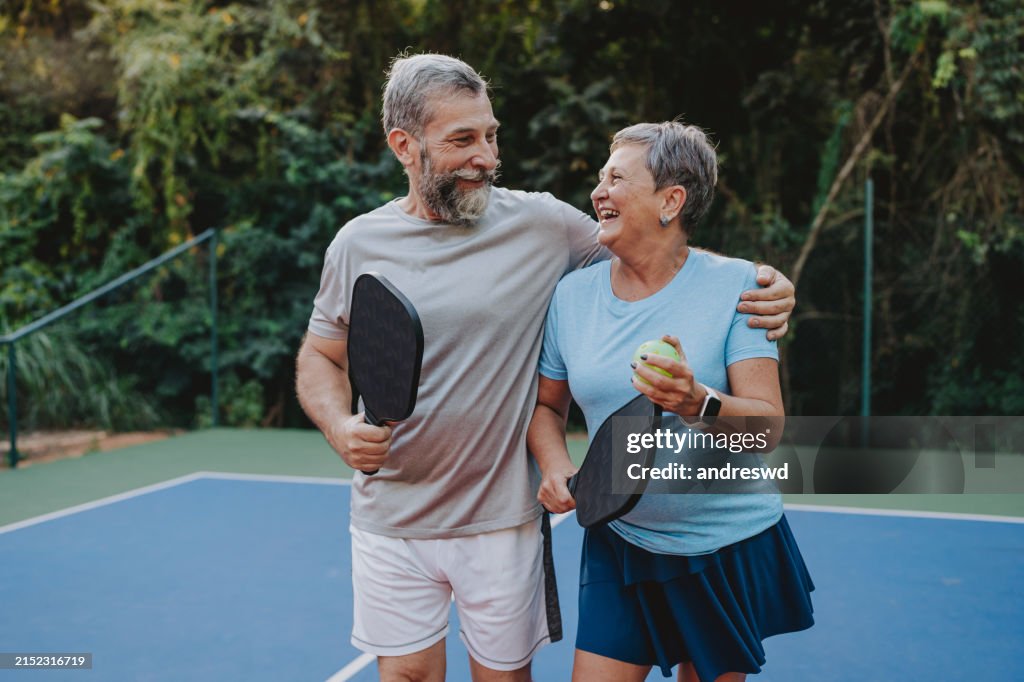 Senior couple playing pickleball
