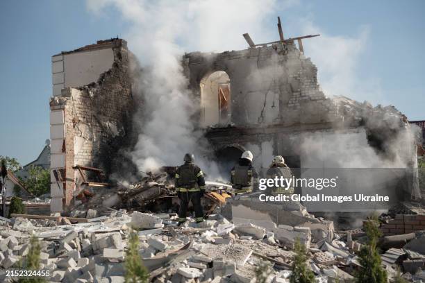 Firefighters finish extinguishing the fire at the site of a Russian missile strike on the city's private residential buildings area on May 10, 2024...