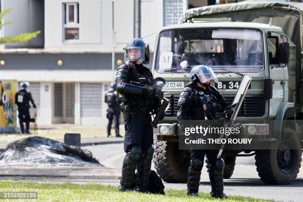 French gendarme officers guard the entrance of the Vallee-du-Tir district, in Noumea on May 14 amid protests linked to a debate on a constitutional...