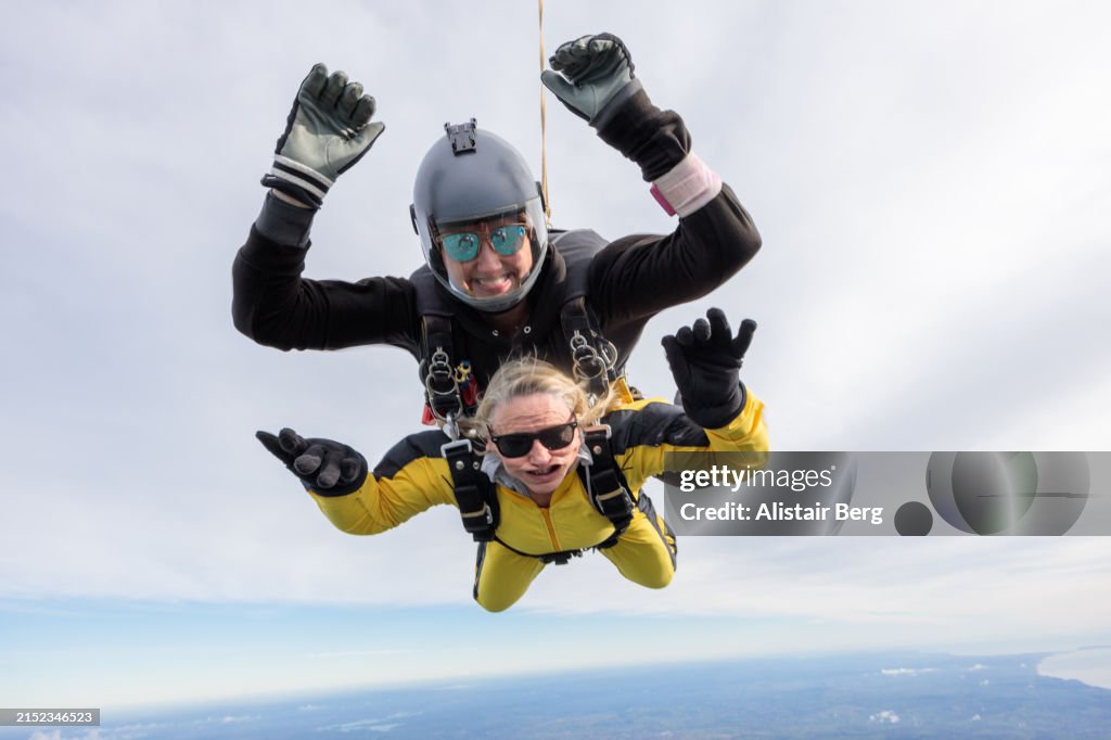 Senior woman enjoying the thrill of her first ever tandem skydive