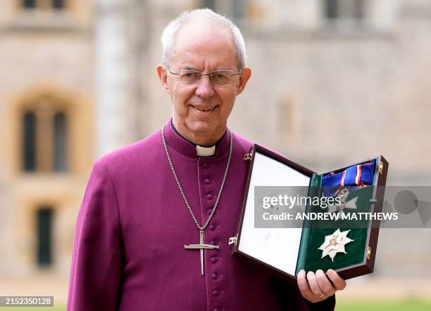 Archbishop of Canterbury Justin Welby poses with his medal and insignia after being appointed as a Knight Grand Cross of the Royal Victorian Order...