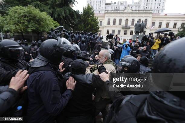 Protesters, staging protest, clash with police officers as they endeavor to breach the security perimeter of the Georgian Parliament building...