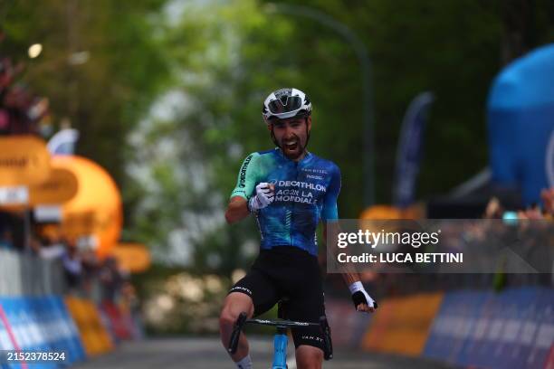 Team Decathlon AG2R's French rider Valentin Paret-Peintre celebrates as he crosses the finish line to win the 10th stage of the 107th Giro d'Italia...