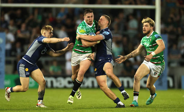 Freddie Steward of Leicester Tigers is tackled by Rob du Preez and Arron Reed during the Gallagher Premiership Rugby match between Sale Sharks and...