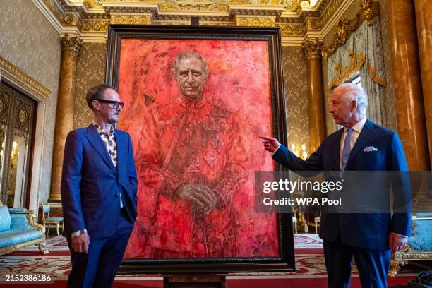 Artist Jonathan Yeo and King Charles III stand in front of the portrait of the King Charles III by artist Jonathan Yeo as it is unveiled in the blue...