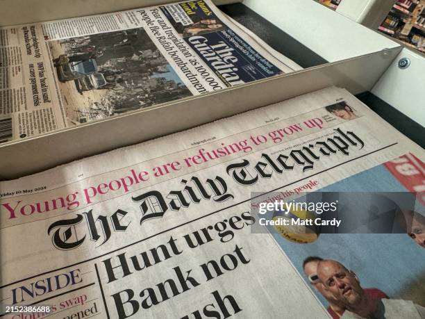 Unsold copies of the Daily Telegraph from various dates are displayed on a newsstand in a newsagent shop on May 4, 2024 in Bath, England. Lloyds...