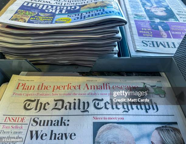 Unsold copies of the Daily Telegraph from various dates are displayed on a newsstand in a newsagent shop on May 4, 2024 in Bath, England. Lloyds...