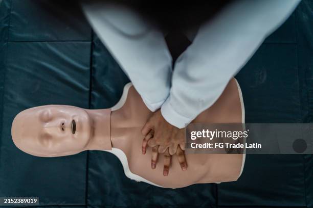 medical student practicing cpr during class at university - cpr stock pictures, royalty-free photos & images