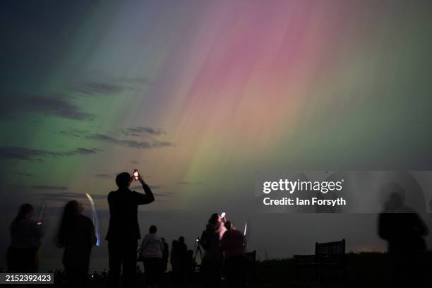 People visit St Mary's lighthouse in Whitley Bay to see the aurora borealis, commonly known as the northern lights, on May 10, 2024 in Whitley Bay,...