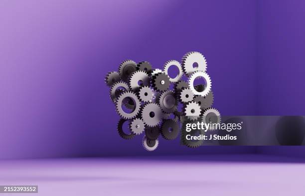 connected gears hovering on the air - verzahnt stock-fotos und bilder