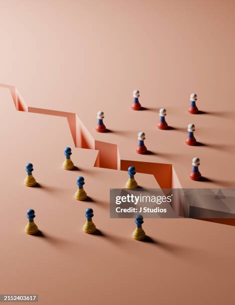 russia and ukraine pawns split by a crack - conflict stock pictures, royalty-free photos & images