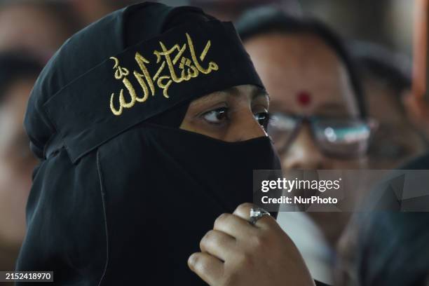 Muslim and Hindu women supporters are attending a public meeting addressed by West Bengal State Chief Minister and TMC Chief Mamata Banerjee during a...