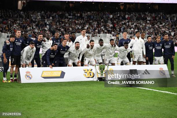 Real Madrid's players pose for a team picture with the Liga trophy, before the start of the Spanish league football match between Real Madrid CF and...