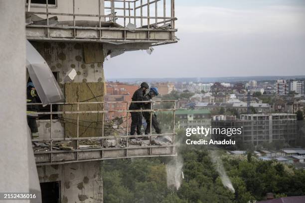 Firefighters cleaning up the debris on the higher floors of a multi-storey residential building after Russian attacks hit Kharkiv, Ukraine on May 14,...